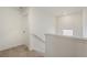 Hallway with carpeted stairs leading to the second floor, and a hallway door at 837 Ledge St, Lochbuie, CO 80603