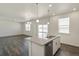 A kitchen island with granite countertops and an open layout to the living area at 837 Ledge St, Lochbuie, CO 80603