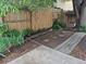 Landscaped backyard with a wood fence, garden and mature trees at 11196 E Baltic Dr, Aurora, CO 80014