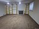 Finished basement with a brick fireplace, carpeted floor and built-in shelving at 11196 E Baltic Dr, Aurora, CO 80014