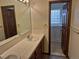 Bathroom with dual sinks, white tile countertops, and walk-in bathtub and glass block window at 11196 E Baltic Dr, Aurora, CO 80014