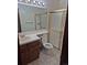 Cozy bathroom featuring sink with vanity, toilet, and a shower with glass sliding doors at 11196 E Baltic Dr, Aurora, CO 80014