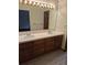 Bathroom featuring and sinks with large mirror and lights for ample brightness at 11196 E Baltic Dr, Aurora, CO 80014
