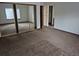 Spacious main bedroom with mirrored closet doors and carpet floor, creating a comfortable retreat at 11196 E Baltic Dr, Aurora, CO 80014