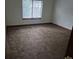 Bright bedroom with neutral carpet and large window for ample light, offering a cozy space to relax at 11196 E Baltic Dr, Aurora, CO 80014