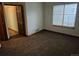Well-lit bedroom with neutral carpet, window with blinds, and a door leading to another room at 11196 E Baltic Dr, Aurora, CO 80014