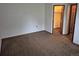 Clean bedroom with neutral carpet and trim, with doorway leading to closet and ensuite bathroom at 11196 E Baltic Dr, Aurora, CO 80014