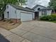 Charming home exterior features a two-car garage, concrete driveway, and tidy landscaping at 11196 E Baltic Dr, Aurora, CO 80014