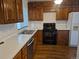 Well-lit kitchen with wood cabinets, white countertops, and modern appliances at 11196 E Baltic Dr, Aurora, CO 80014