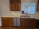 Stylish kitchen area with stainless steel appliances, wood cabinets, and a view of the living room at 11196 E Baltic Dr, Aurora, CO 80014