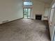 Spacious living room featuring a cozy fireplace, vaulted ceilings and ample natural light with access to backyard through sliding doors at 11196 E Baltic Dr, Aurora, CO 80014