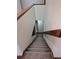 Carpeted stairway with wooden handrail offers a safe and stylish transition between floors at 11196 E Baltic Dr, Aurora, CO 80014