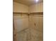 A standard walk-in closet with shelving and rod in need of cleaning at 11196 E Baltic Dr, Aurora, CO 80014