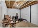 Unfinished basement with exposed ceiling beams and storage at 16845 Buffalo Valley Path, Monument, CO 80132