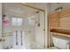Clean bathroom with a shower/tub combo and a bamboo storage cabinet at 16845 Buffalo Valley Path, Monument, CO 80132