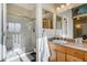Bright bathroom featuring a shower, single sink vanity, and linen closet at 16845 Buffalo Valley Path, Monument, CO 80132