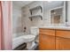 Basement bathroom with shower/tub combo and wood cabinets at 16845 Buffalo Valley Path, Monument, CO 80132