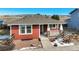 Red house with gray trim and a stone porch at 16845 Buffalo Valley Path, Monument, CO 80132