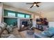 Living room with fireplace, built-in shelving, and large TV at 16845 Buffalo Valley Path, Monument, CO 80132