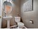 Stylish powder room with pedestal sink, toilet and decorative wall art at 16845 Buffalo Valley Path, Monument, CO 80132