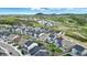 Aerial view of neighborhood showcasing housing development surrounded by lush greenery and mountain views at 624 Simmental Loop, Castle Rock, CO 80104