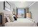 Bedroom showcasing a queen bed with neutral walls and carpet, with a view of the outside at 624 Simmental Loop, Castle Rock, CO 80104