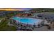 Wide shot of the stunning community pool and clubhouse with lounge seating and manicured landscaping at 624 Simmental Loop, Castle Rock, CO 80104