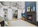Living room showcasing a fireplace, an open staircase, and hardwood floors at 624 Simmental Loop, Castle Rock, CO 80104