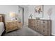 Bedroom showing wooden nightstands on a gray carpeted floor, with a partial view of the bathroom at 624 Simmental Loop, Castle Rock, CO 80104