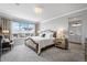 Bright main bedroom with a large window, neutral colors and a connected bathroom with double sinks at 624 Simmental Loop, Castle Rock, CO 80104