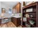 Home office features custom built-ins, a spacious desk area, and wood flooring at 624 Simmental Loop, Castle Rock, CO 80104