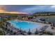 Stunning community pool and recreation center with ample seating and manicured landscaping at dusk at 624 Simmental Loop, Castle Rock, CO 80104