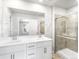 Modern bathroom with double sink vanity, a large mirror, and a glass enclosed shower at 22495 E 7Th Pl, Aurora, CO 80018