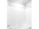 Minimalist bathroom featuring white tiles, a bathtub, and a shower head at 22495 E 7Th Pl, Aurora, CO 80018