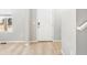 Welcoming entryway features light wood floors, a white front door, and a view of the exterior at 22495 E 7Th Pl, Aurora, CO 80018