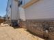 Exterior view showcasing stone foundation and siding of the house with landscape at 22495 E 7Th Pl, Aurora, CO 80018