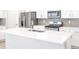 Modern kitchen featuring white cabinets, stainless steel appliances, and a spacious quartz countertop island at 22495 E 7Th Pl, Aurora, CO 80018