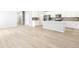 Bright open-concept space with wood floors extends from the living area into a modern kitchen with a center island at 22495 E 7Th Pl, Aurora, CO 80018