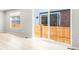 Bright living room with sliding glass doors leading to a fenced backyard and light wood floors at 22495 E 7Th Pl, Aurora, CO 80018