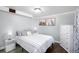 Well-lit bedroom with a comfortable bed, side tables, a dresser, and desert artwork at 5132 Eaton St, Denver, CO 80212