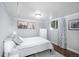 Well-lit bedroom with a comfortable bed, side tables, a dresser, and desert artwork at 5132 Eaton St, Denver, CO 80212