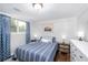 Cozy bedroom with hardwood floors, a striped bedspread, and contemporary decor at 5132 Eaton St, Denver, CO 80212