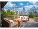 Inviting outdoor deck with cozy furniture and a peaceful, tree-lined backdrop at 5132 Eaton St, Denver, CO 80212