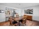 Open-concept dining room with hardwood floors and an elegant, connecting breakfast bar at 5132 Eaton St, Denver, CO 80212