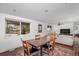 Bright dining room with hardwood floors, a large window, and an adjacent living area at 5132 Eaton St, Denver, CO 80212