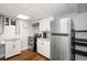 Bright kitchen with stainless steel appliances, white cabinets, and dark wood flooring at 5132 Eaton St, Denver, CO 80212