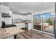 Bright kitchen featuring white cabinets, granite countertops, and a sliding door to the deck at 5132 Eaton St, Denver, CO 80212