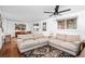 Comfortable living room with hardwood floors, neutral sofas, and a view into the dining area at 5132 Eaton St, Denver, CO 80212