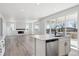 Bright and airy kitchen with white cabinetry and an island with a dishwasher at 1100 Joseph Pl, Erie, CO 80026