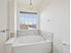 Bathroom boasts a large soaking tub and a window with natural light at 4321 W 118Th Pl, Westminster, CO 80031